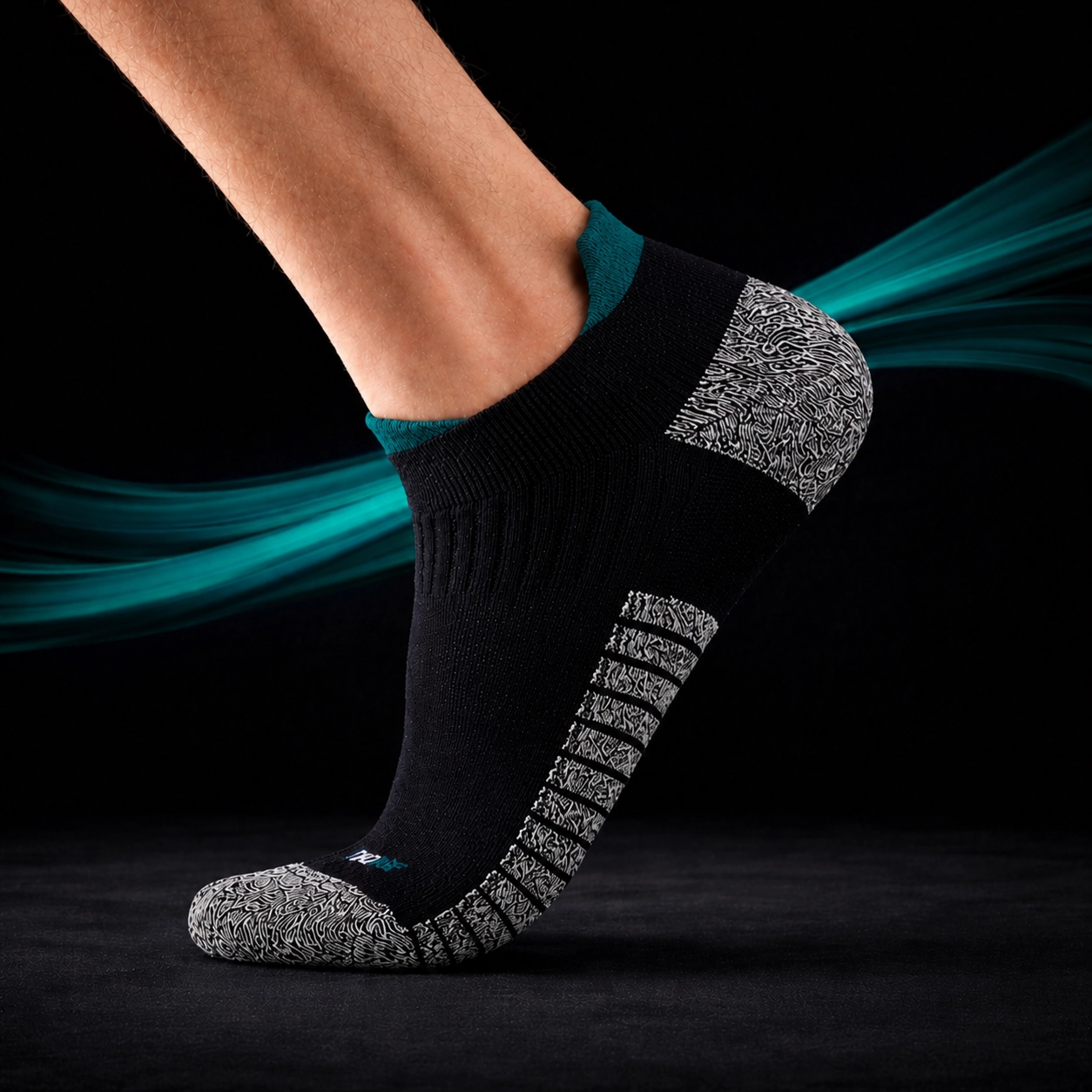 A leg wearing a SHTOOMF climbing sock with teal highlights and a teal swirl around against a black background