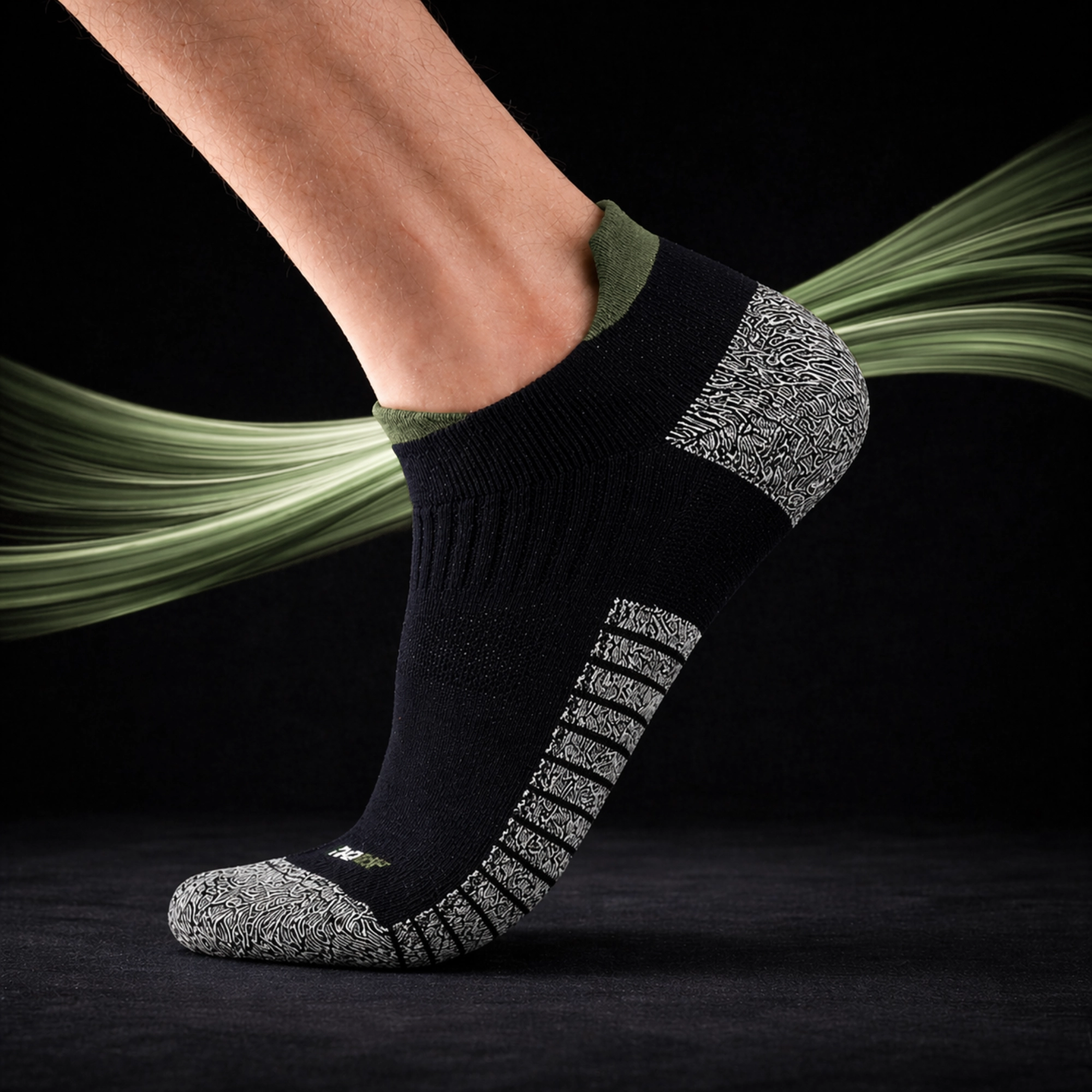 A leg wearing a SHTOOMF climbing sock with green highlights and a green swirl around against a black background